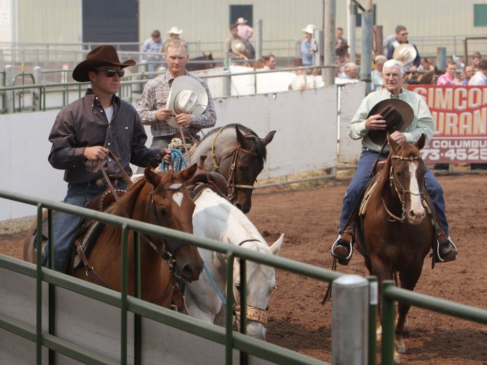 Men remove their hats and cover their hearts for the Star Spangled Banner.