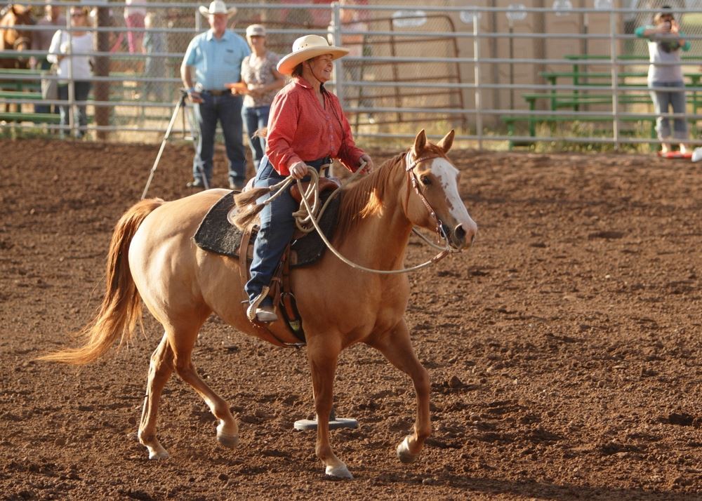 Woman rides her horse in the arena at the 2014 Klickitat County Fair.