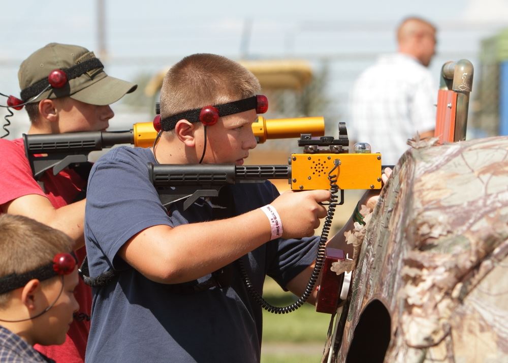Boys play with laser guns at the 2014 Klickitat County Fair.