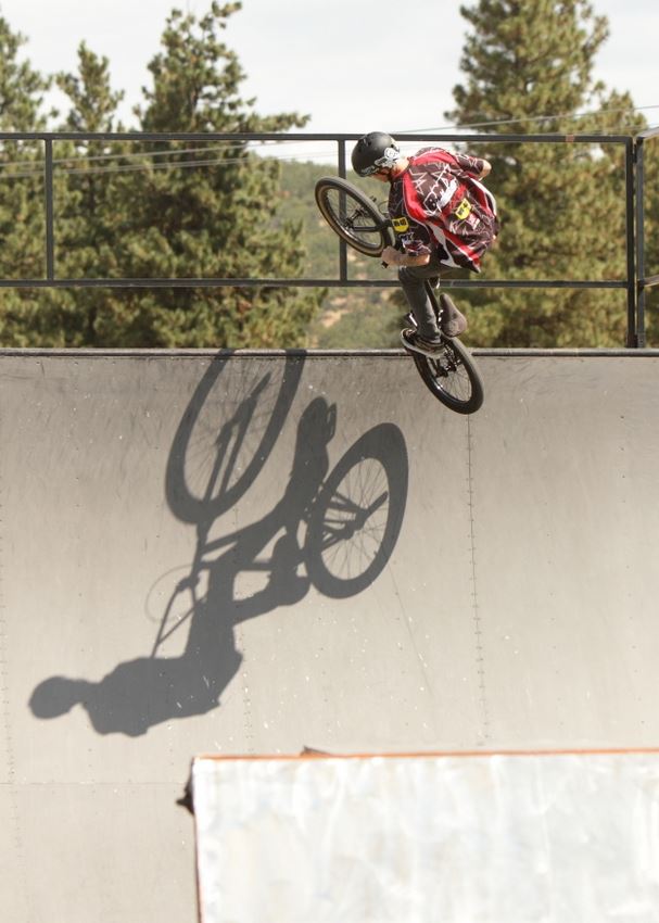 A man does tricks on his BMX bike.