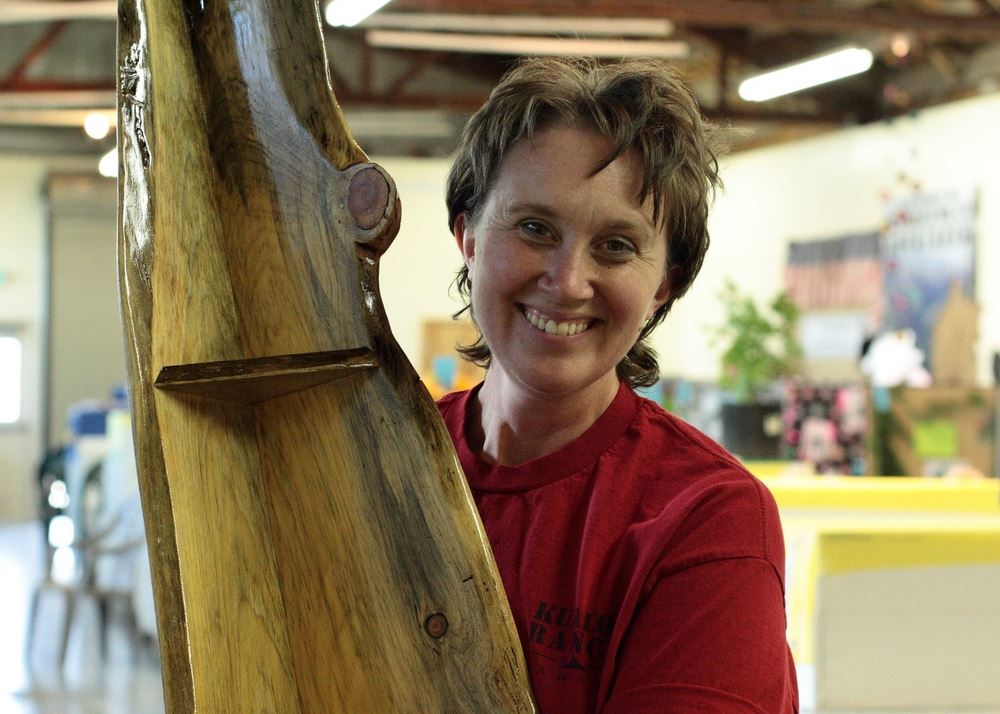 A woman shows a beautiful wooden shelf at the 2014 Klickitat County Fair.