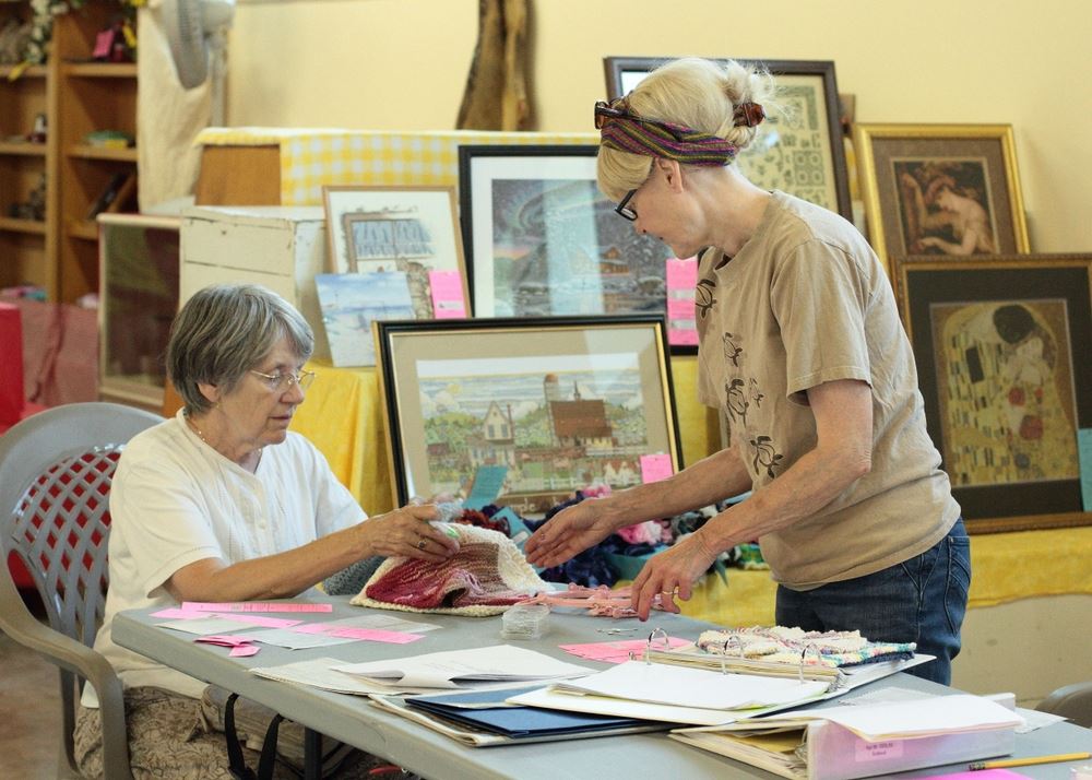 Two women discuss knitted items at the 2014 Klickitat County Fair.