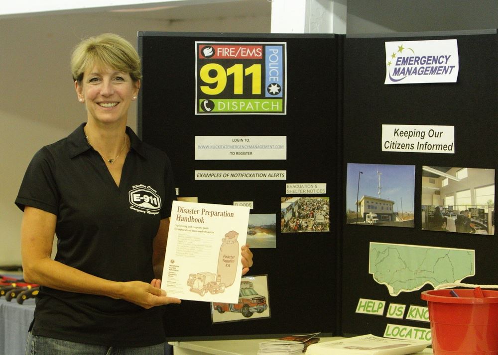 A woman poses at the 911 exhibit at the 2014 Klickitat County Fair.
