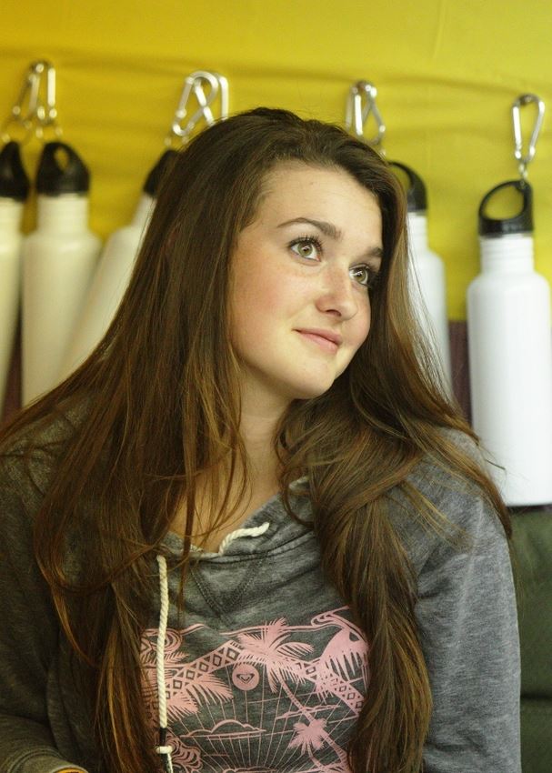A girl shrugs at the Waste Reduction exhibit.