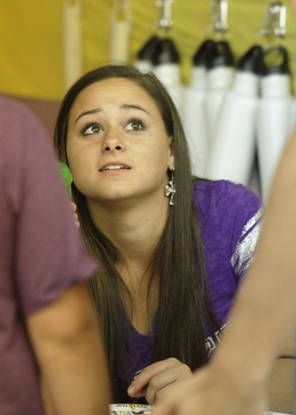 A girl works at the Waste Reduction exhibit.