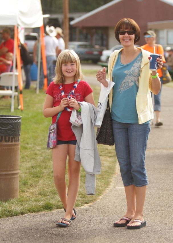 A woman and little girl stop to smile at the 2014 Klickitat County Fair.