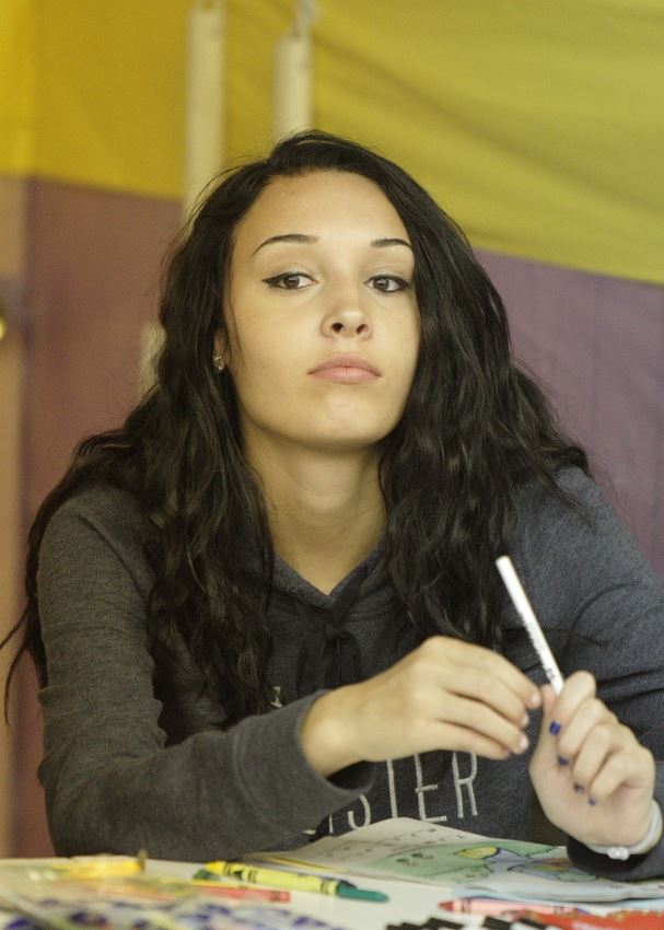 A girl holds an ink pen at a booth at the 2014 Klickitat County Fair.