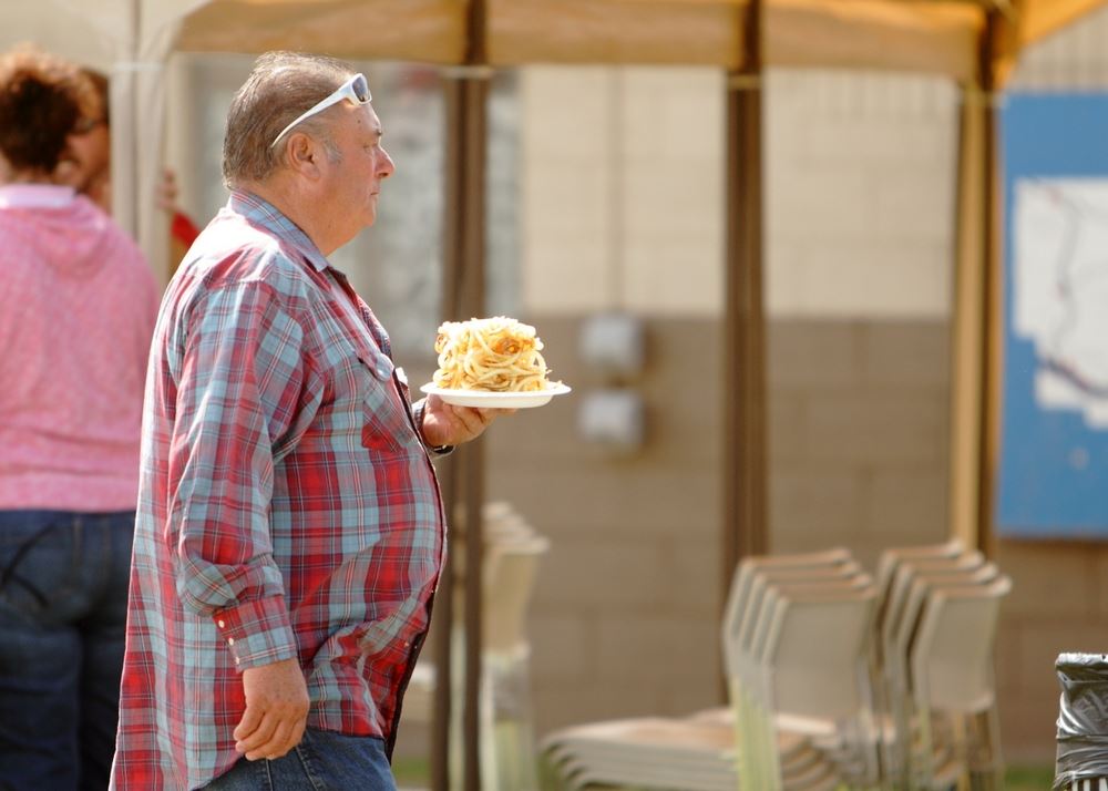 A man holds a plate of curly fries at the 2014 Klickitat County Fair.