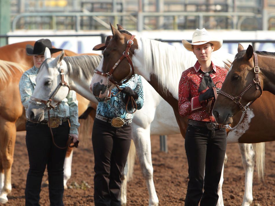 Young women stand next to their horses at the 2015 Klickitat County Fair.