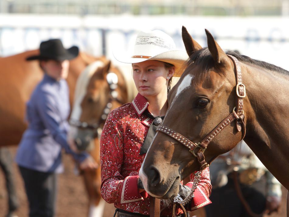 A young woman stands next to her horse at the 2015 Klickitat County Fair.
