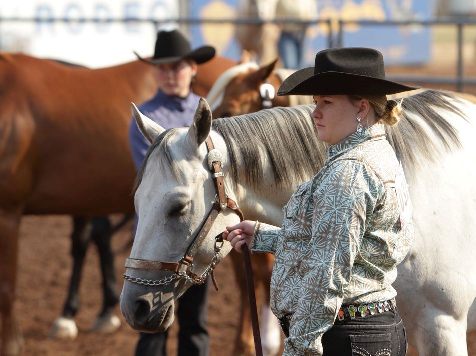 A young woman stands next to her horse at the 2015 Klickitat County Fair.