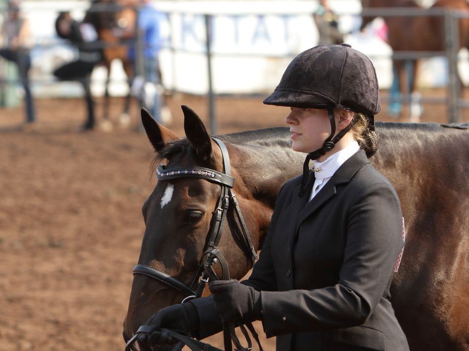 A young woman stands next to her horse at the 2015 Klickitat County Fair.