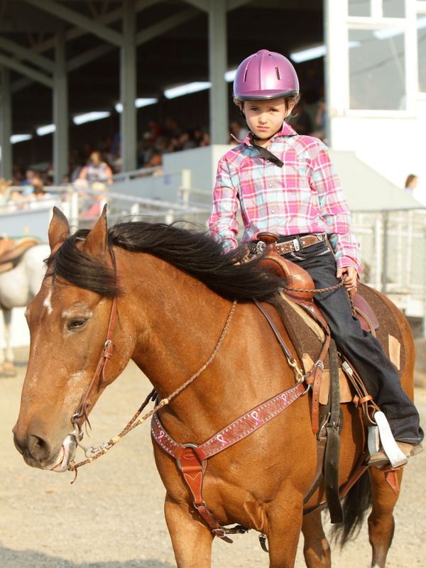 A young girl sits atop her horse at the 2015 Klickitat County Fair.