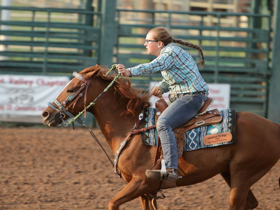 A girl runs her horse at the 2015 Klickitat County Fair.