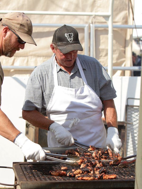 Two men work to barbecue food for the 2015 Klickitat County Fair.