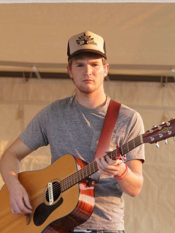 Young man plays his acoustic guitar at the 2015 Klickitat County Fair.