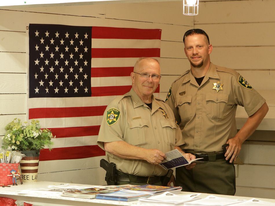 Members of the Klickitat County Sheriff's Department stand at an exhibit.